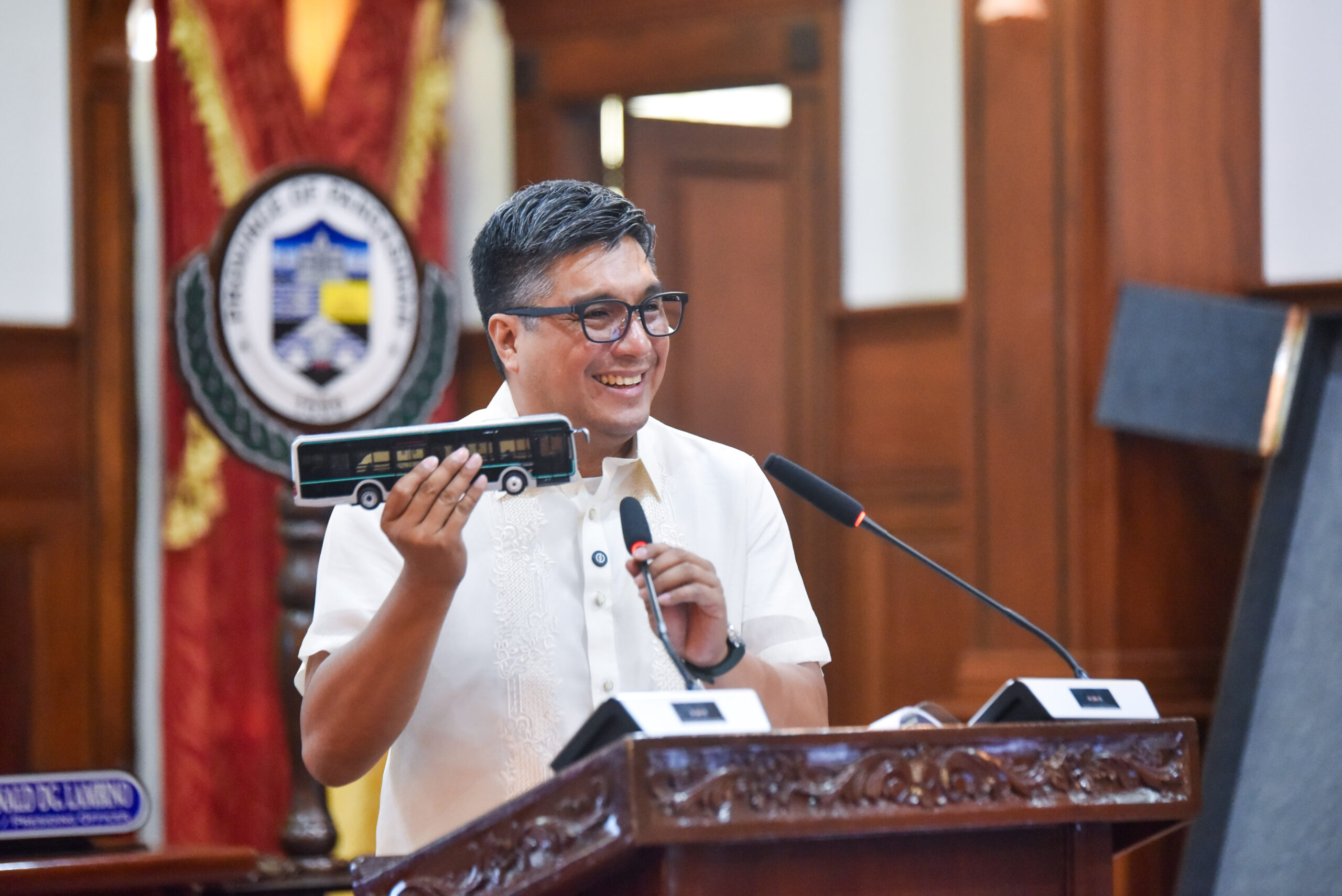 Visual of Gov. Guico showcasing a miniature of the bus model for the EV-BRT program.